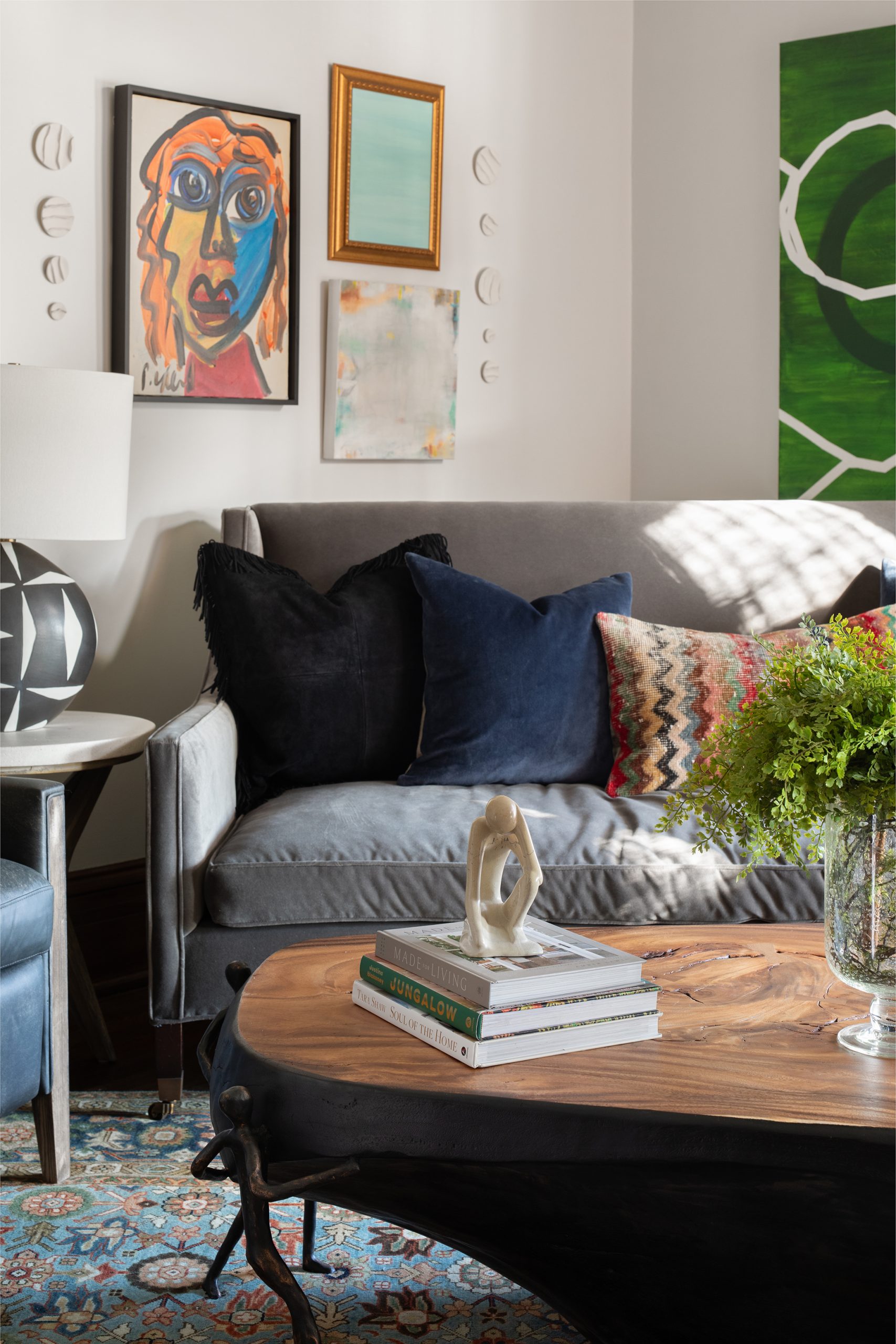 An eclectic living room with colorful gallery wall and live-edge coffee table